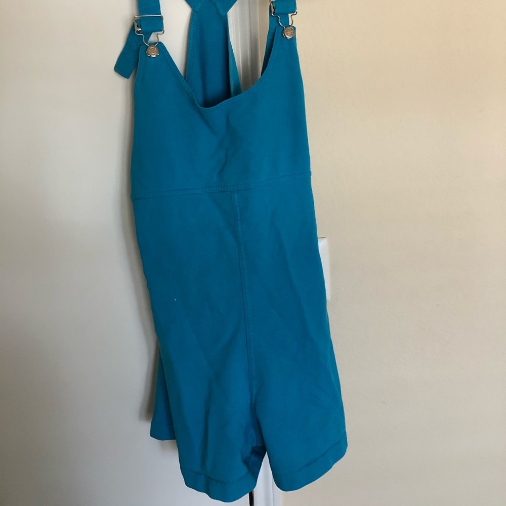 Blue overall shorts.